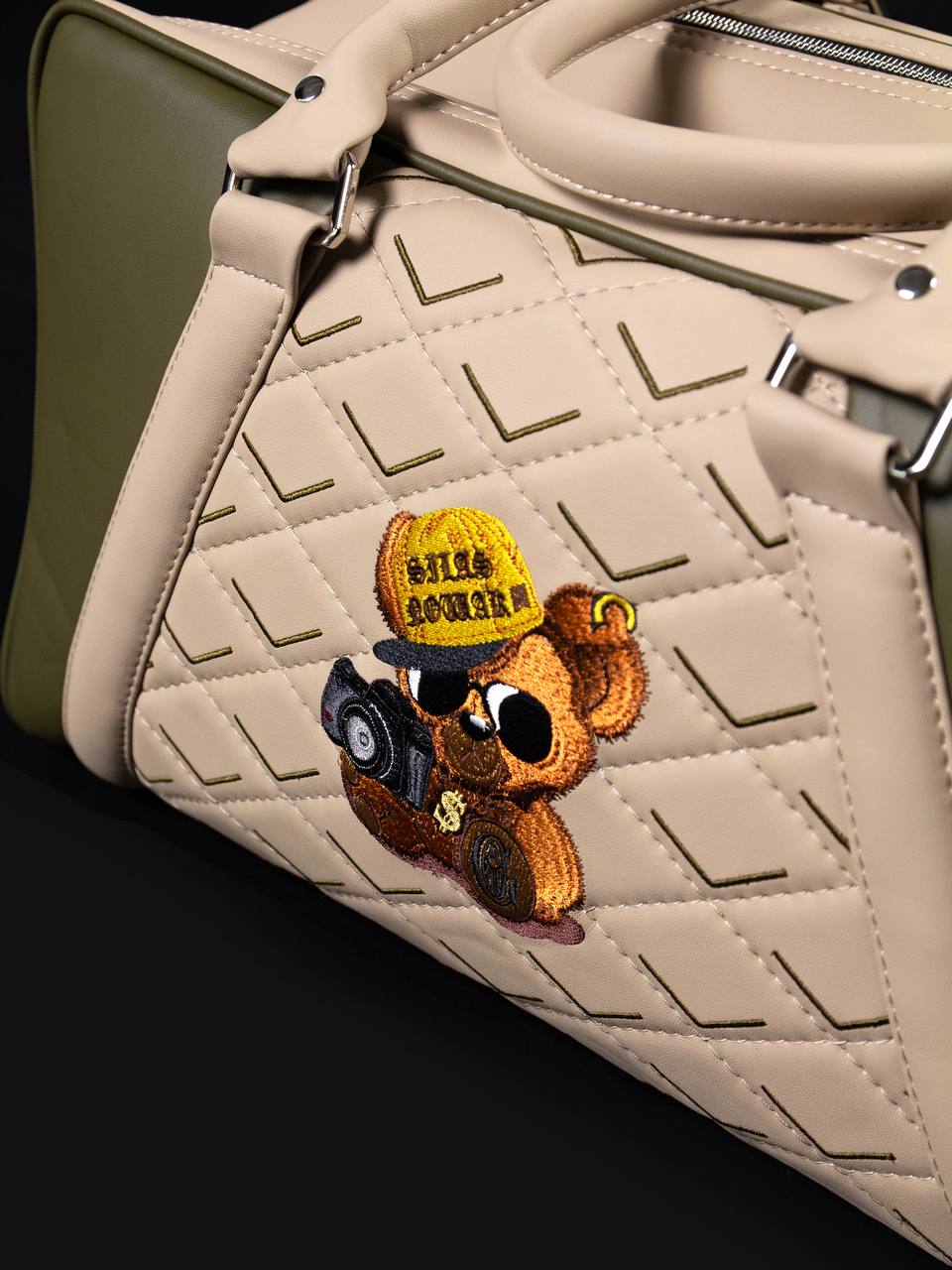 Hand-embroidered bear motif on quilted sand leather