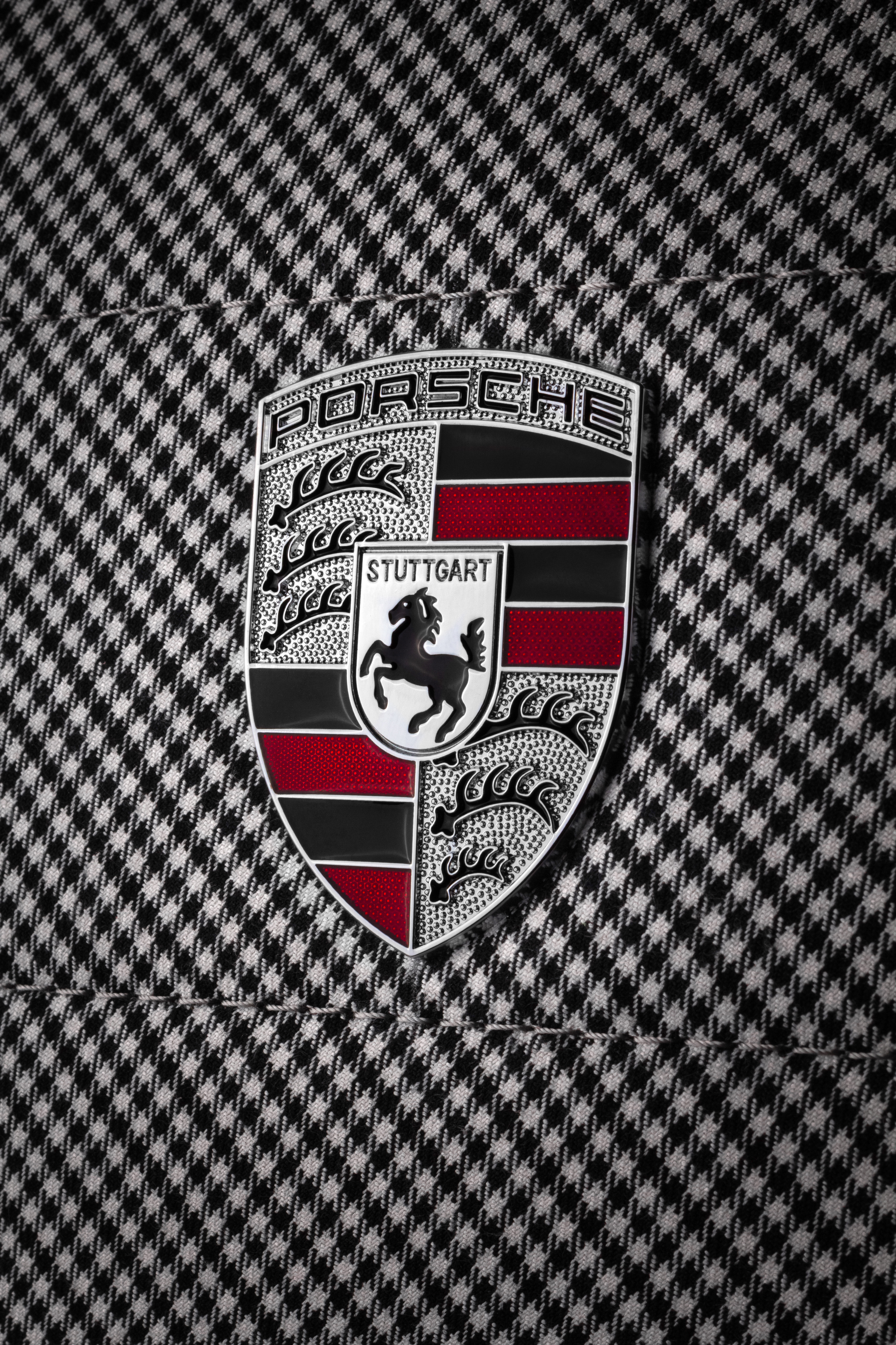 Enamel Porsche crest set into the houndstooth panel