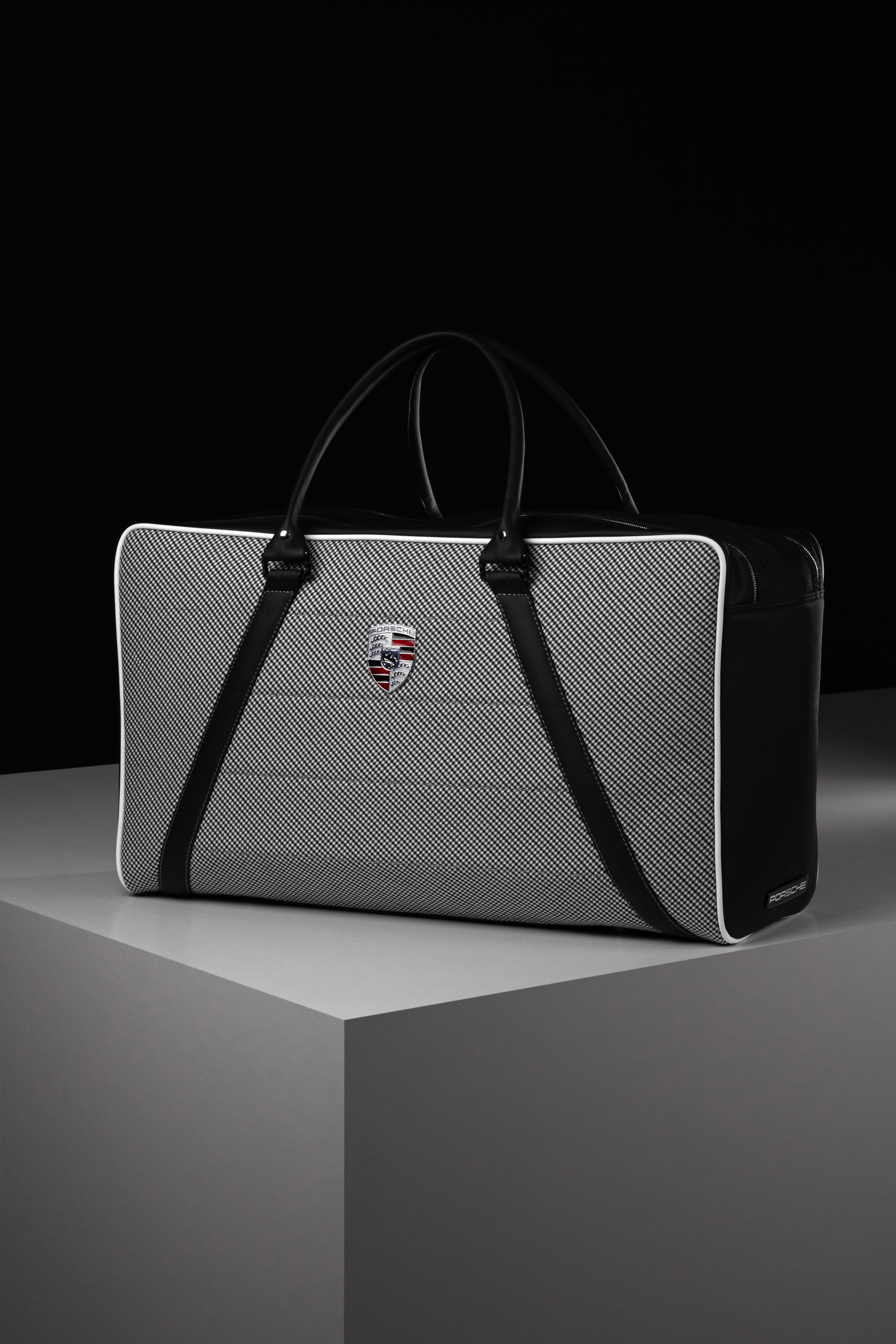 Porsche houndstooth weekender with leather trim and crest